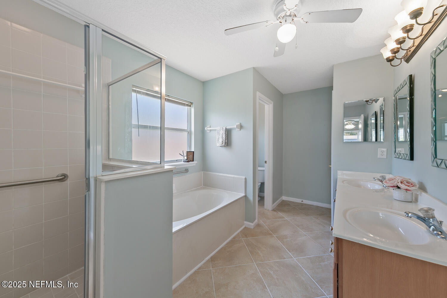 9317 Beresford Court Jacksonville, FL 32244 - Photo 28 of 55 a bathroom with a tub sink vanity and mirror