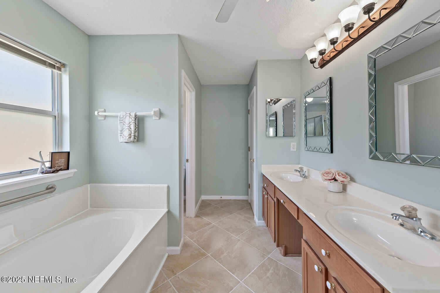 9317 Beresford Court Jacksonville, FL 32244 - Photo 29 of 55 a spacious bathroom with a tub sink and mirror