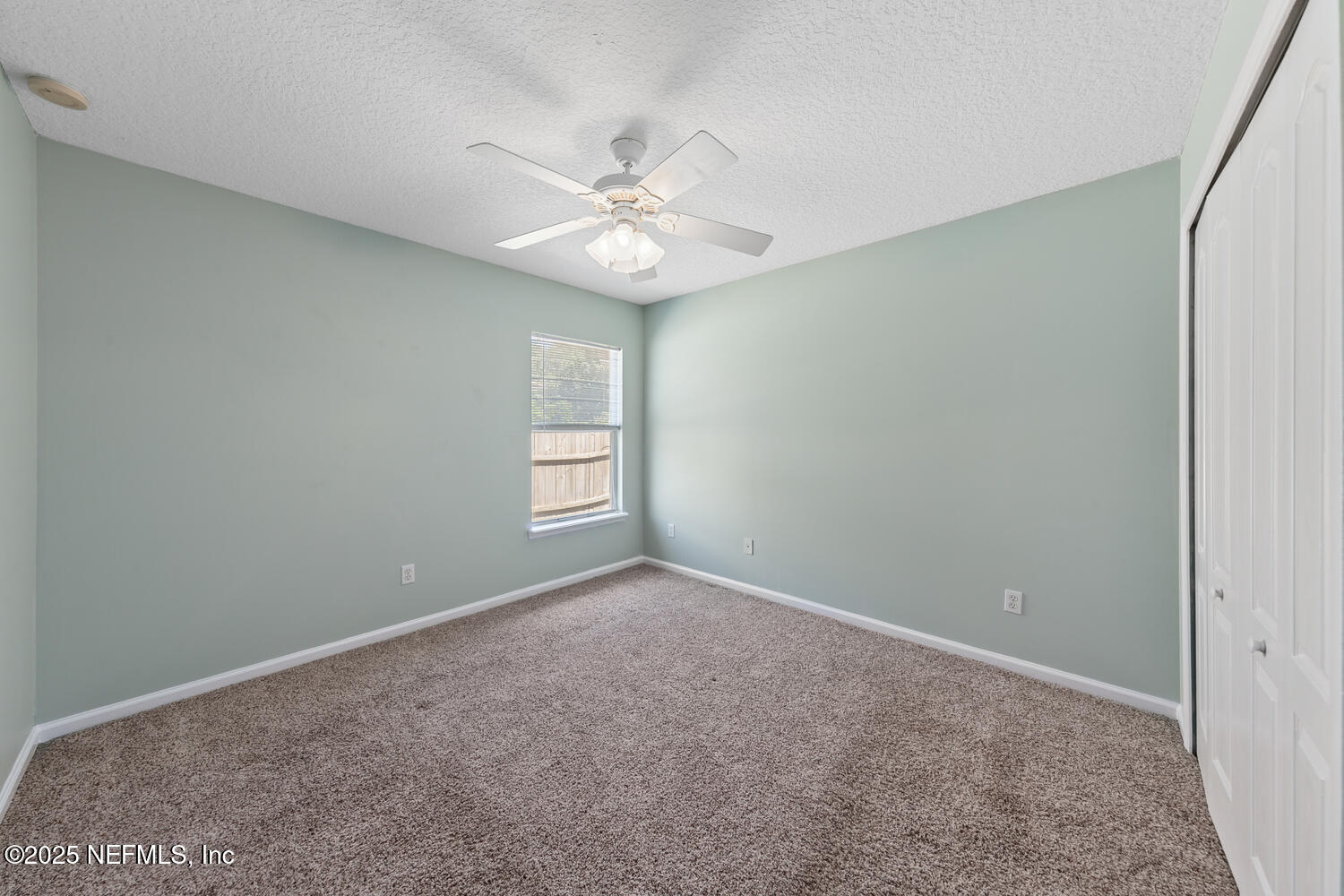 9317 Beresford Court Jacksonville, FL 32244 - Photo 30 of 55 an empty room with windows and fan