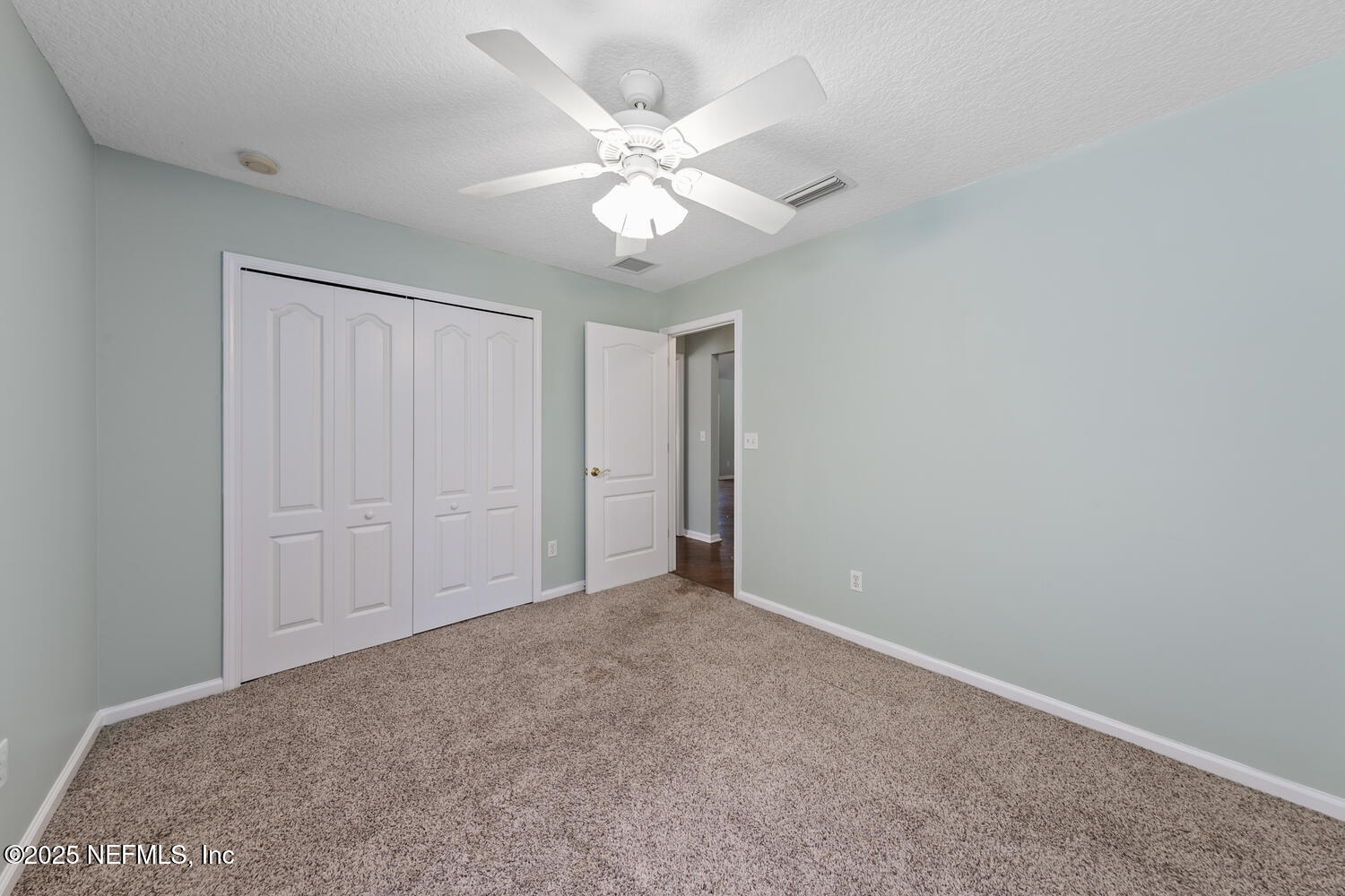 9317 Beresford Court Jacksonville, FL 32244 - Photo 33 of 55 an empty room with closet and a ceiling fan