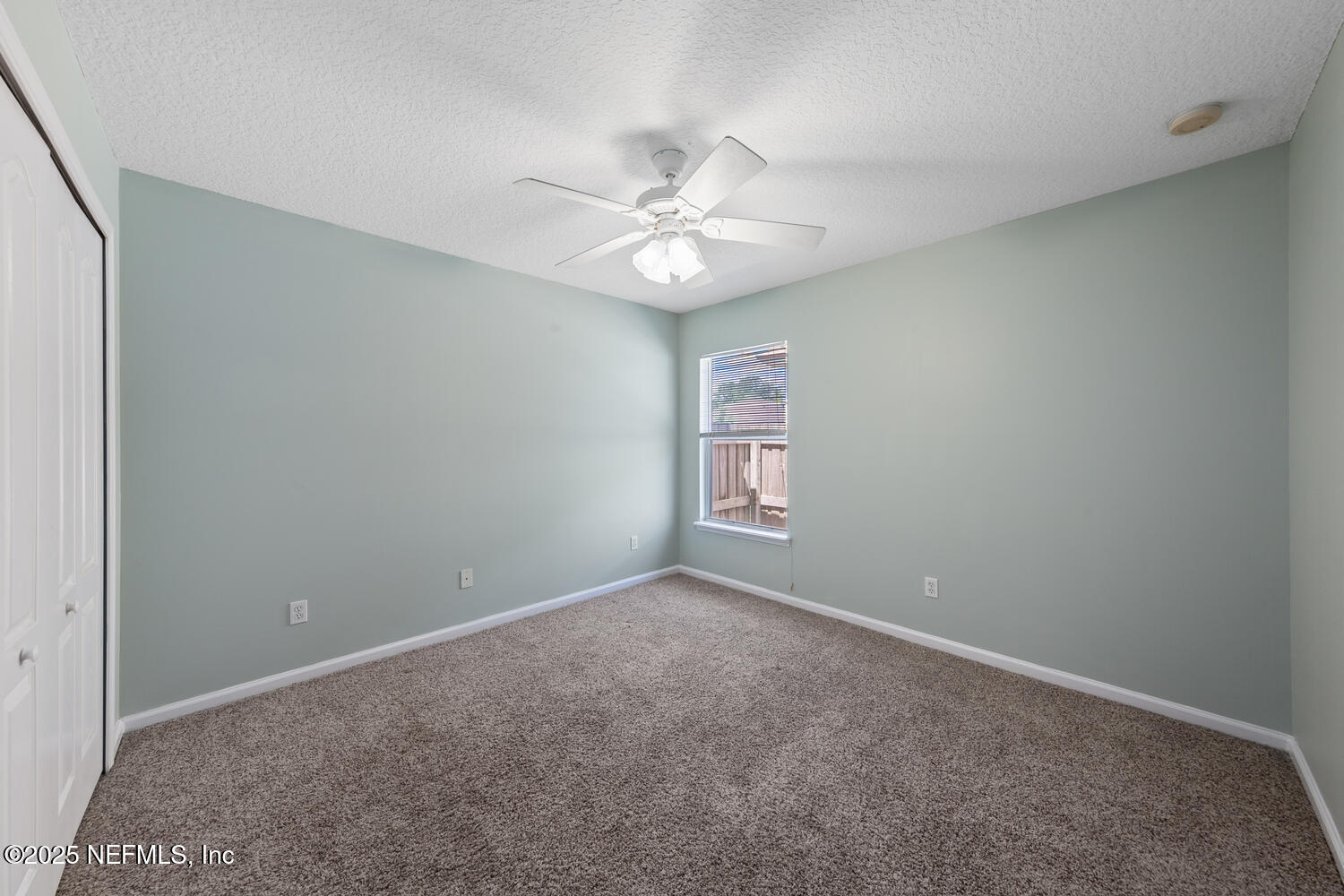 9317 Beresford Court Jacksonville, FL 32244 - Photo 35 of 55 an empty room with windows and fan