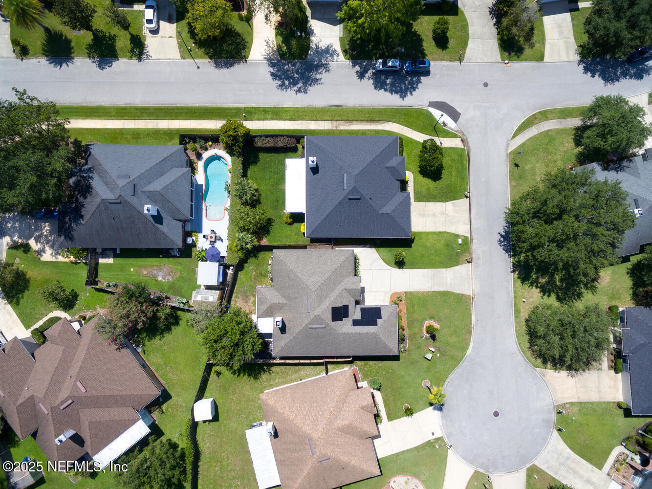 9317 Beresford Court Jacksonville, FL 32244 - Photo 47 of 55 an aerial view of swimming pool with outdoor seating and trees