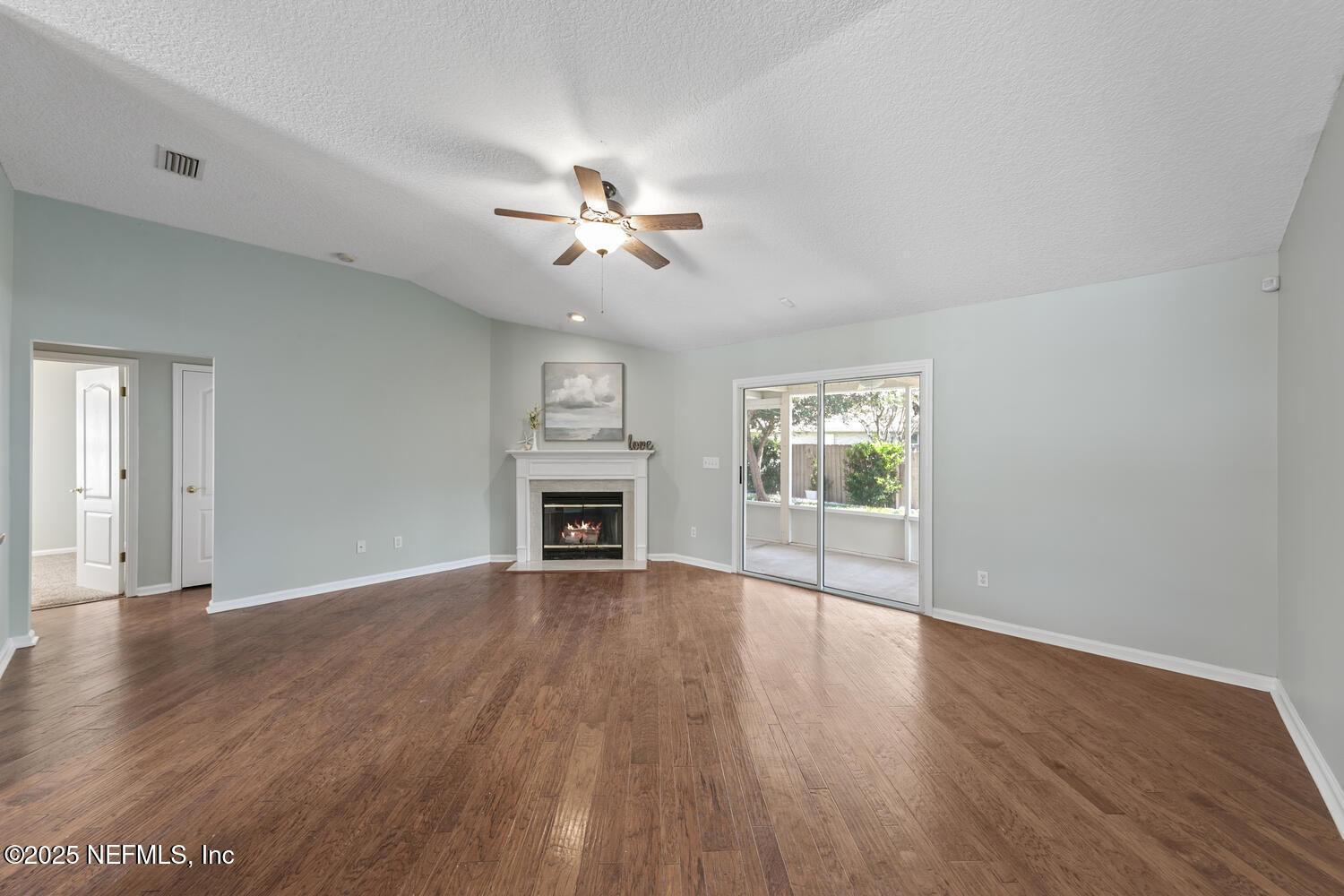 9317 Beresford Court Jacksonville, FL 32244 - Photo 10 of 55 a view of an empty room with wooden floor and a window