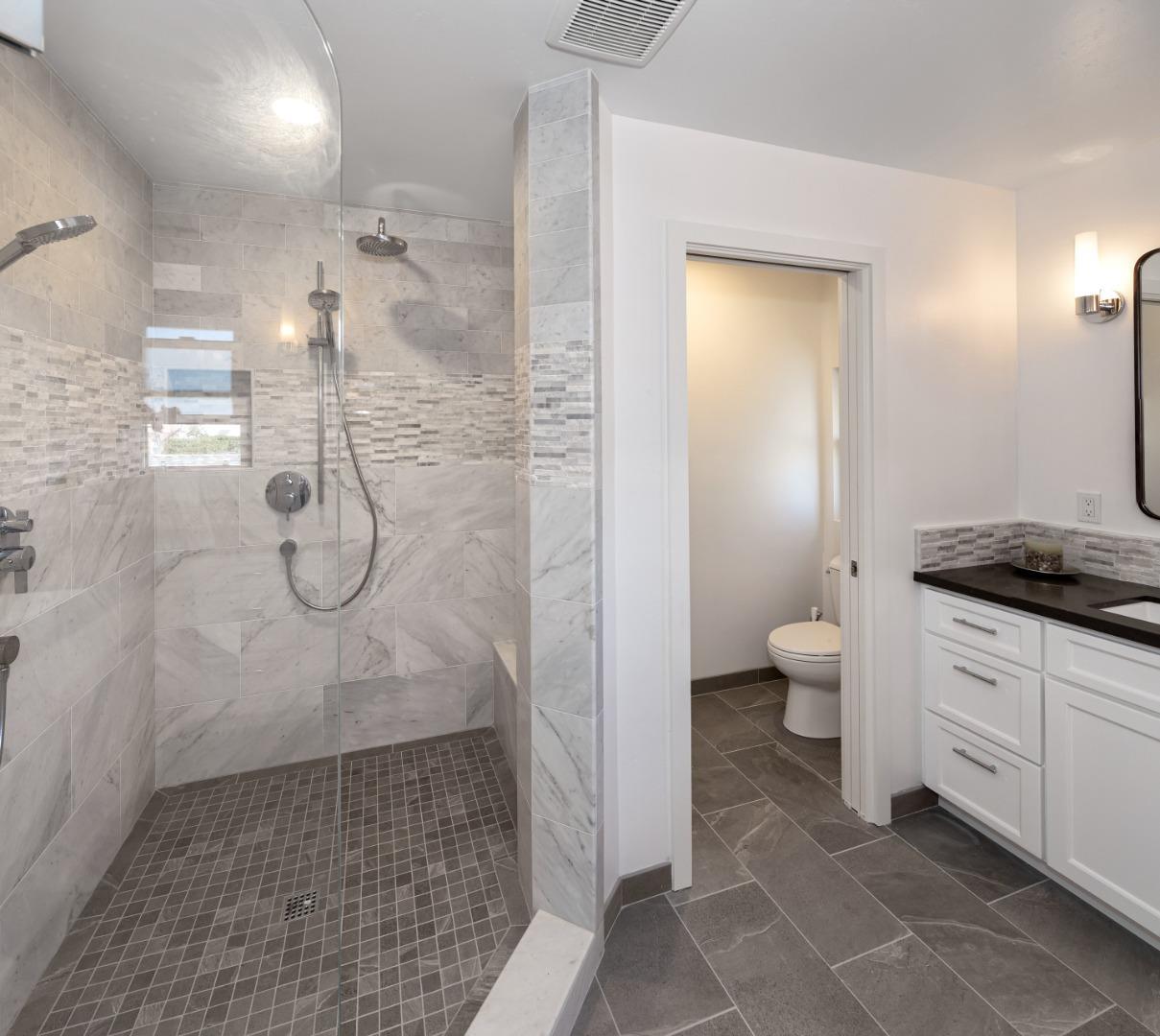 150 Vía Soderini Aptos, CA 95003 - Photo 15 of 36 a bathroom with a granite countertop shower a sink and a toilet