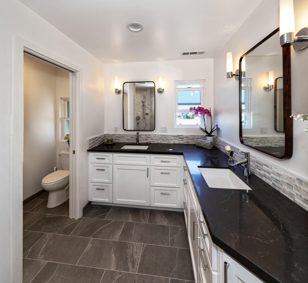 150 Vía Soderini Aptos, CA 95003 - Photo 23 of 36 a spacious bathroom with a granite countertop sink and a mirror