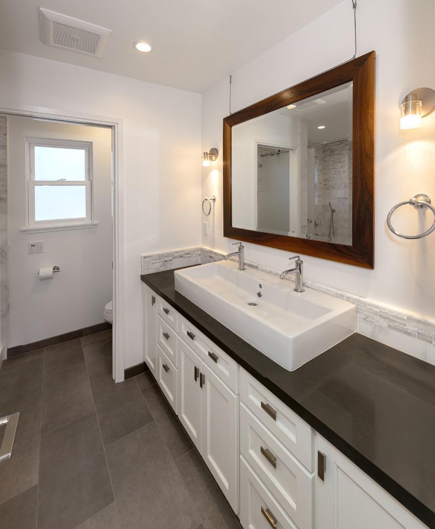 150 Vía Soderini Aptos, CA 95003 - Photo 27 of 36 a bathroom with a double vanity sink and mirror