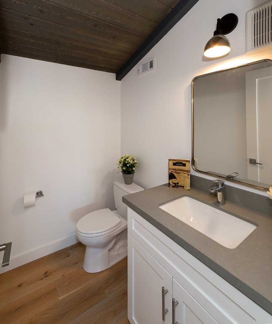 150 Vía Soderini Aptos, CA 95003 - Photo 30 of 36 a bathroom with a granite countertop sink a toilet and a mirror
