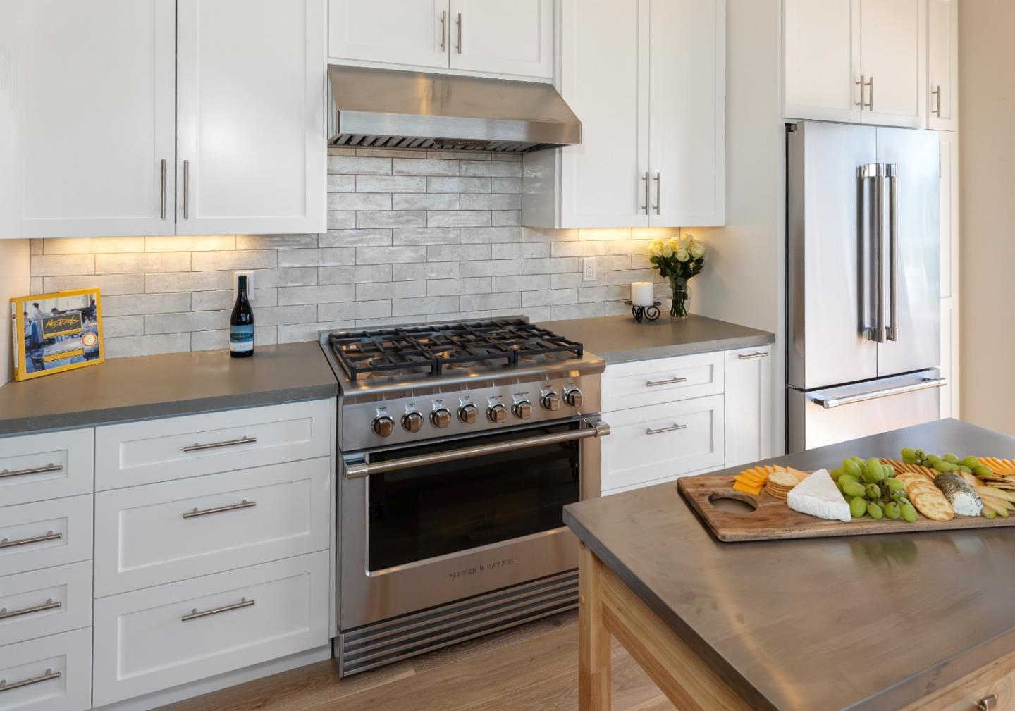 150 Vía Soderini Aptos, CA 95003 - Photo 6 of 36 a kitchen with stainless steel appliances white cabinets and a stove