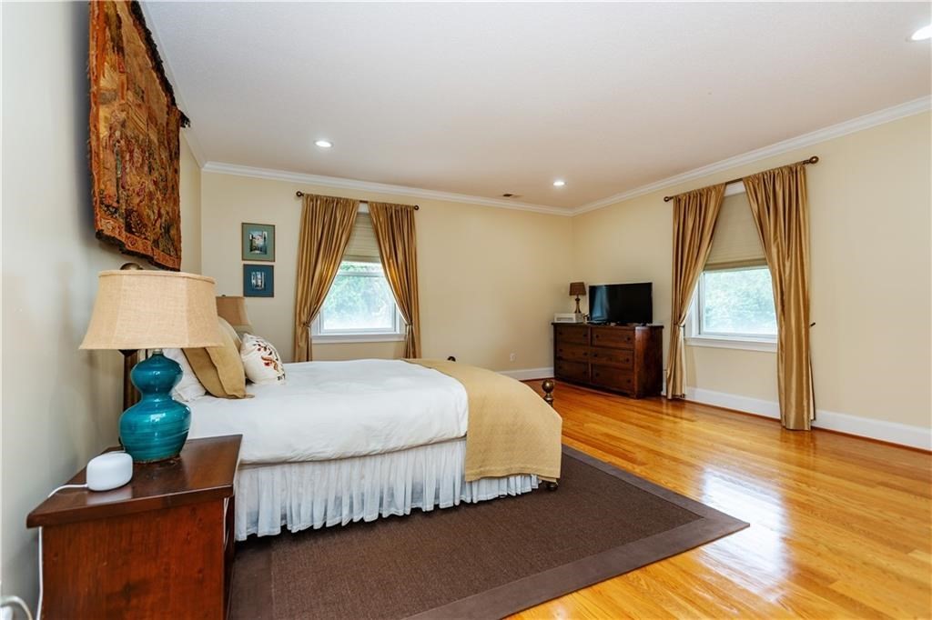 7 Gibson Avenue, Unit 7 Narragansett, RI 02882 - Photo 14 of 27 a spacious bedroom with a bed and wooden floor