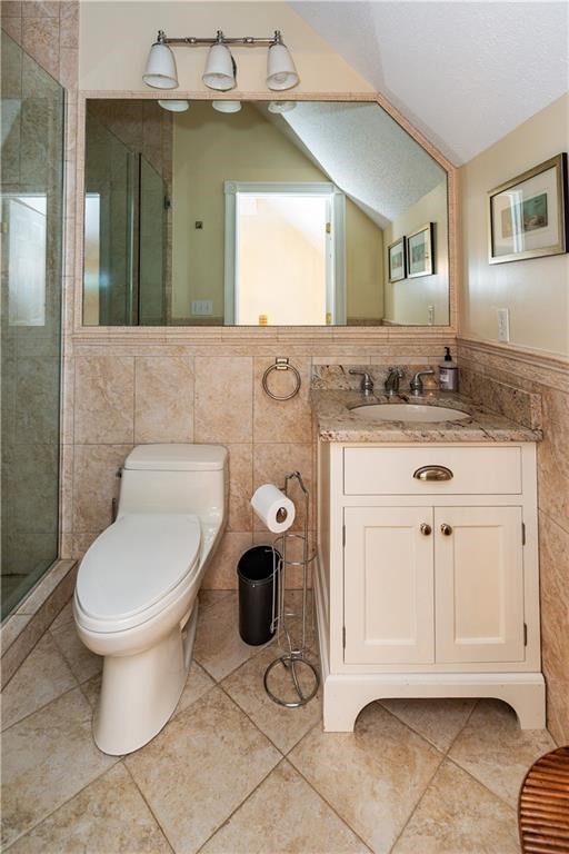 7 Gibson Avenue, Unit 7 Narragansett, RI 02882 - Photo 24 of 27 a bathroom with a toilet sink and mirror