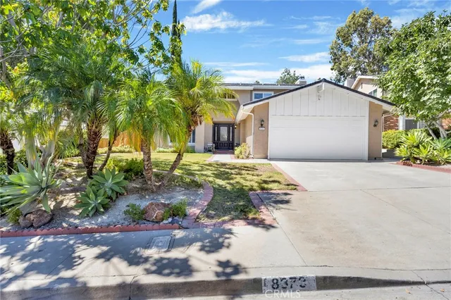 a view of a house with a yard and plant