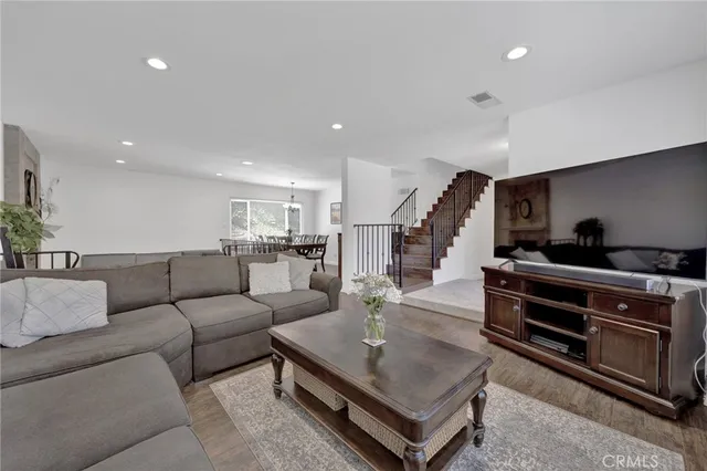 a dining room with furniture potted plants and wooden floor