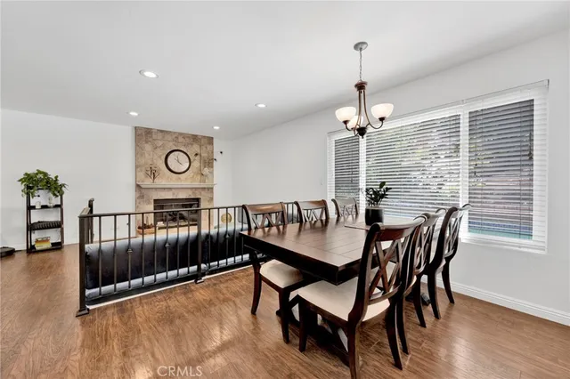 a living room with furniture and a dining table with kitchen view