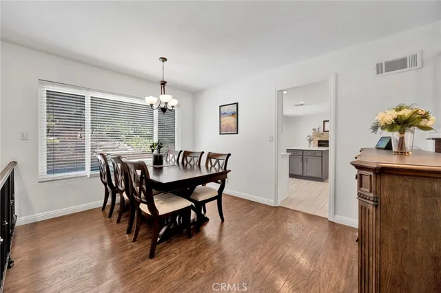 a dining room with furniture and wooden floor