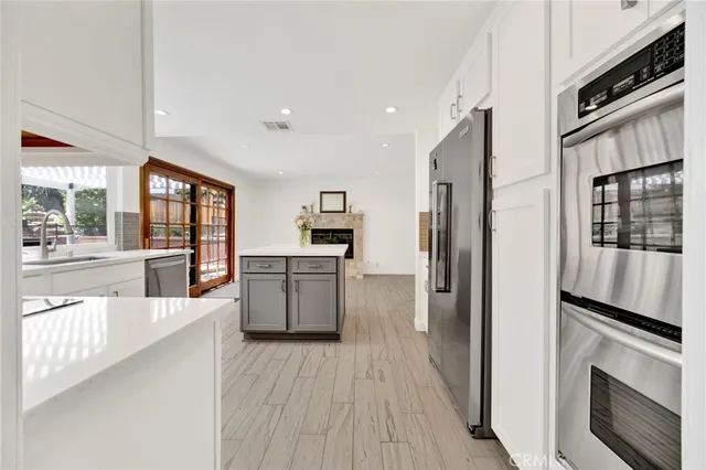 a kitchen with counter top space a sink cabinets and appliances