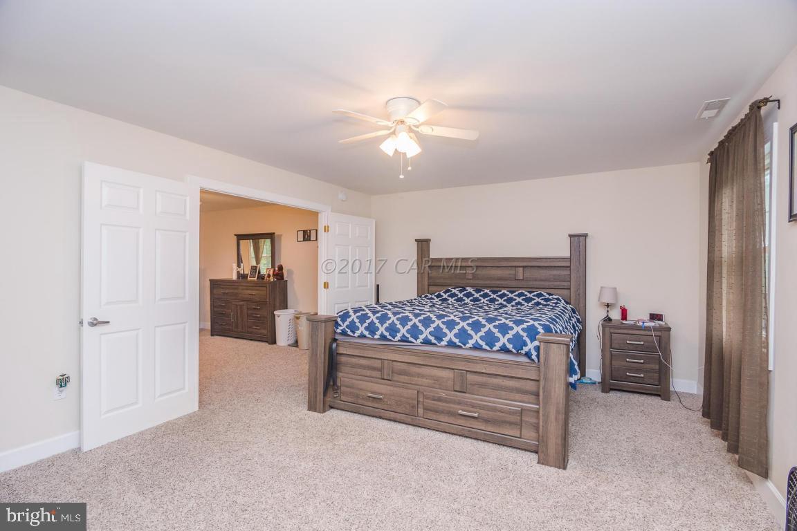 29632 Deal Island Road Princess Anne, MD 21853 - Photo 8 of 33 a bedroom with a bed and a chandelier