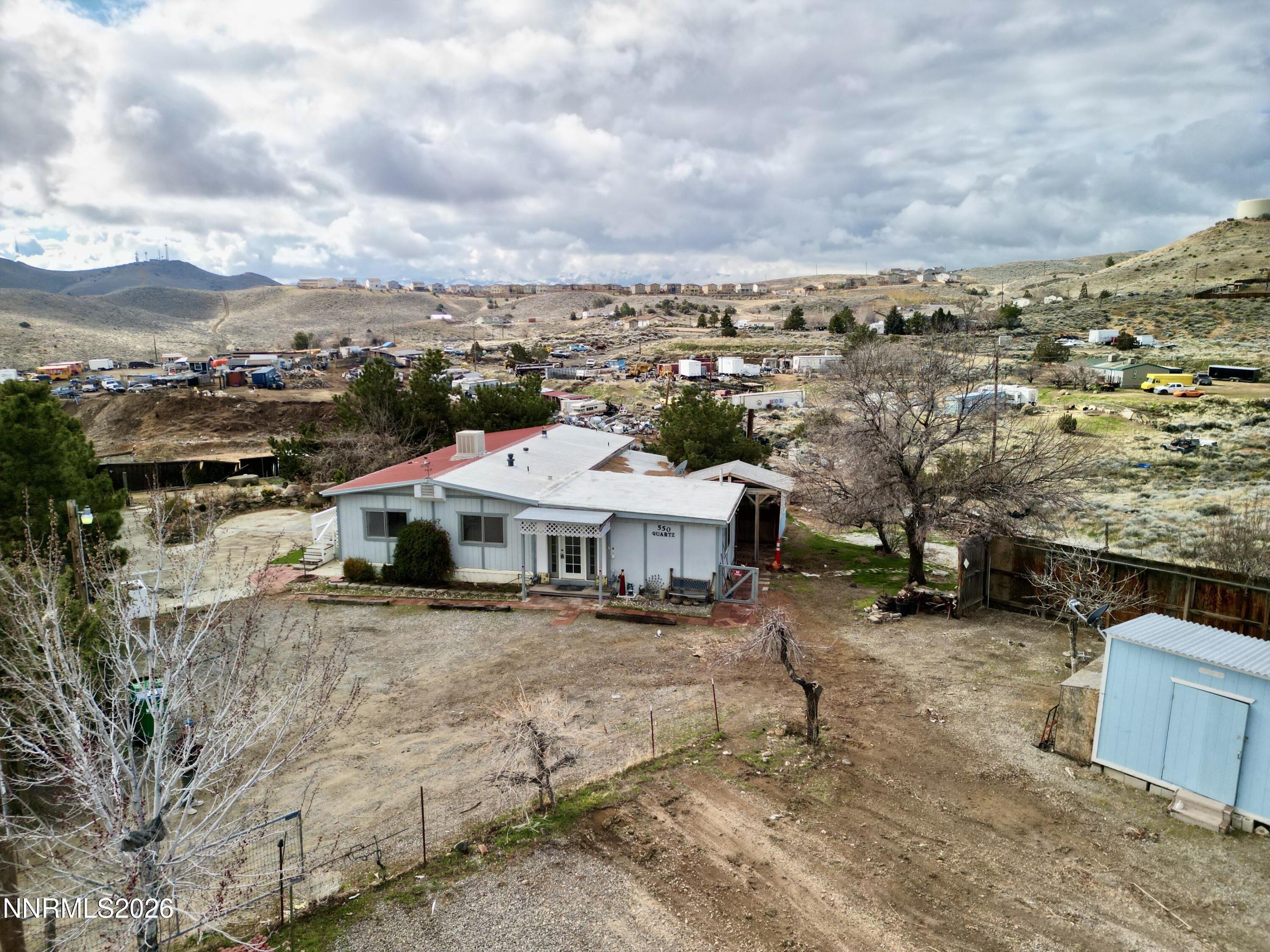 550 Quartz Lane Sun Valley, NV 89433 - Photo 1 of 31 a view of a big house with a big yard and large trees