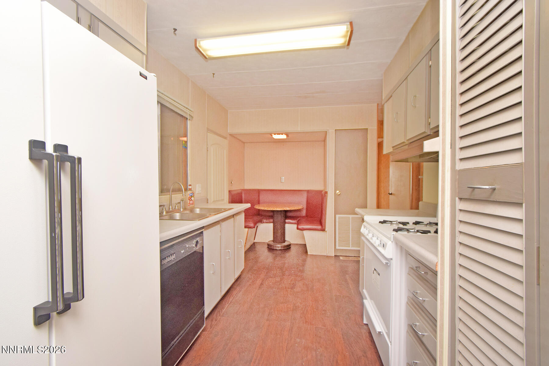 550 Quartz Lane Sun Valley, NV 89433 - Photo 8 of 31 a kitchen with stainless steel appliances a stove a sink and a refrigerator