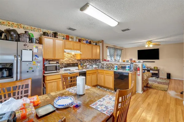 a kitchen with stainless steel appliances kitchen island granite countertop a sink and cabinets