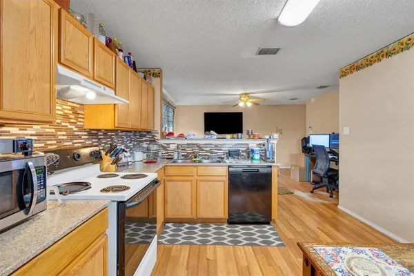 a kitchen with a sink appliances and cabinets