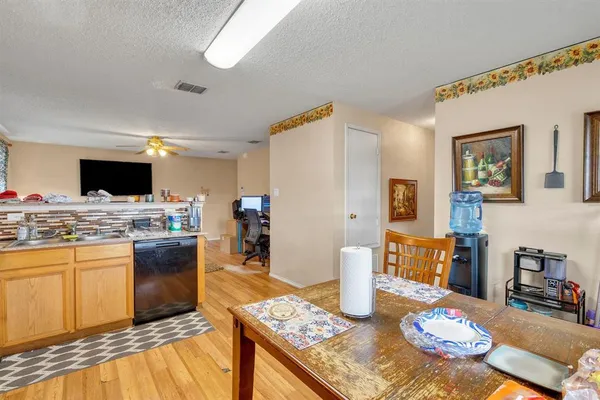 a kitchen with stainless steel appliances kitchen island granite countertop a sink and cabinets