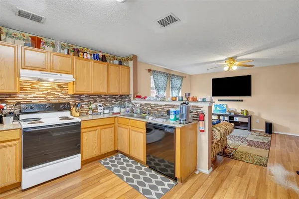 a kitchen with stainless steel appliances granite countertop a stove and a sink