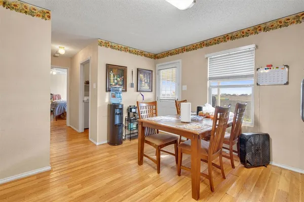 a view of a dining room with furniture and wooden floor