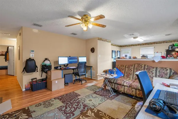 a living room with furniture and wooden floor