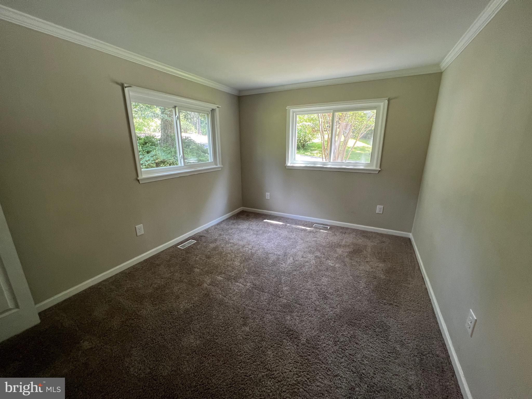 18402 Cedar Drive, Unit A Triangle, VA 22172 - Photo 7 of 9 an empty room with windows