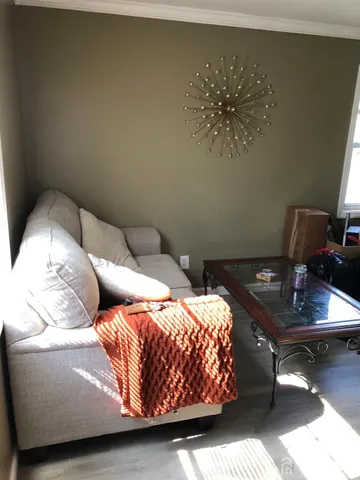 a bedroom with a bed and a lamp on dresser