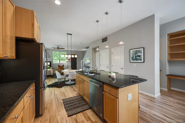 a kitchen with sink refrigerator and stove