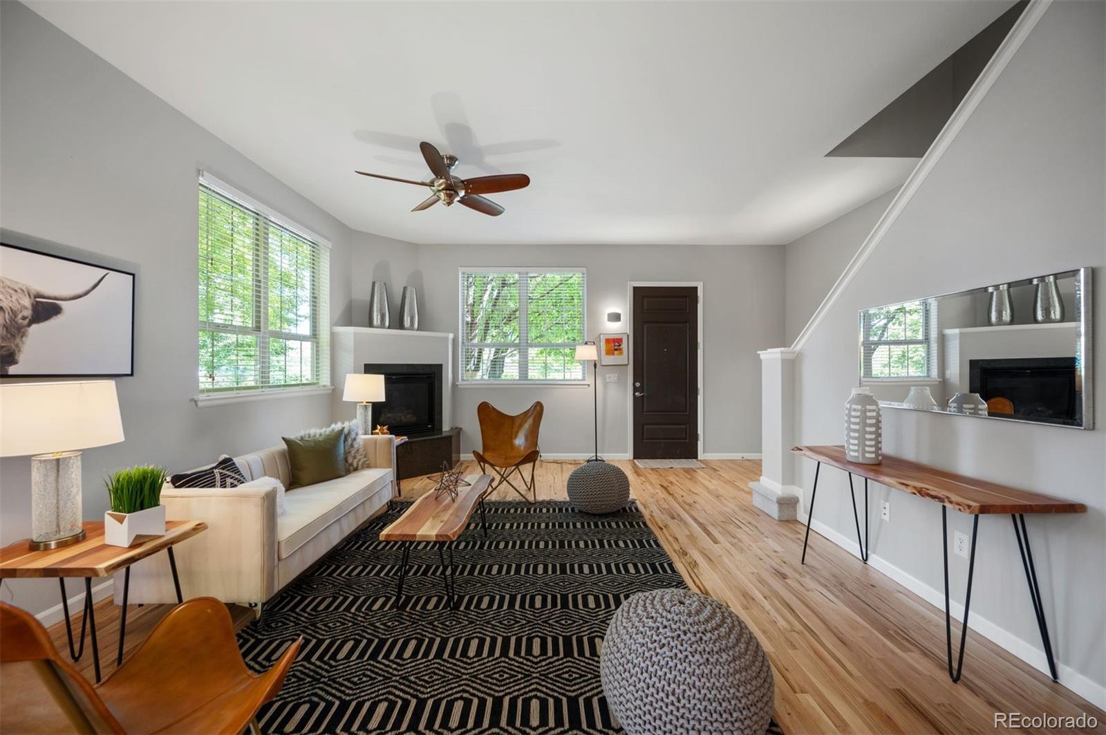 217 Spruce Street, Unit 101 Denver, CO 80230 - Photo 15 of 37 a living room with furniture a window and a fireplace