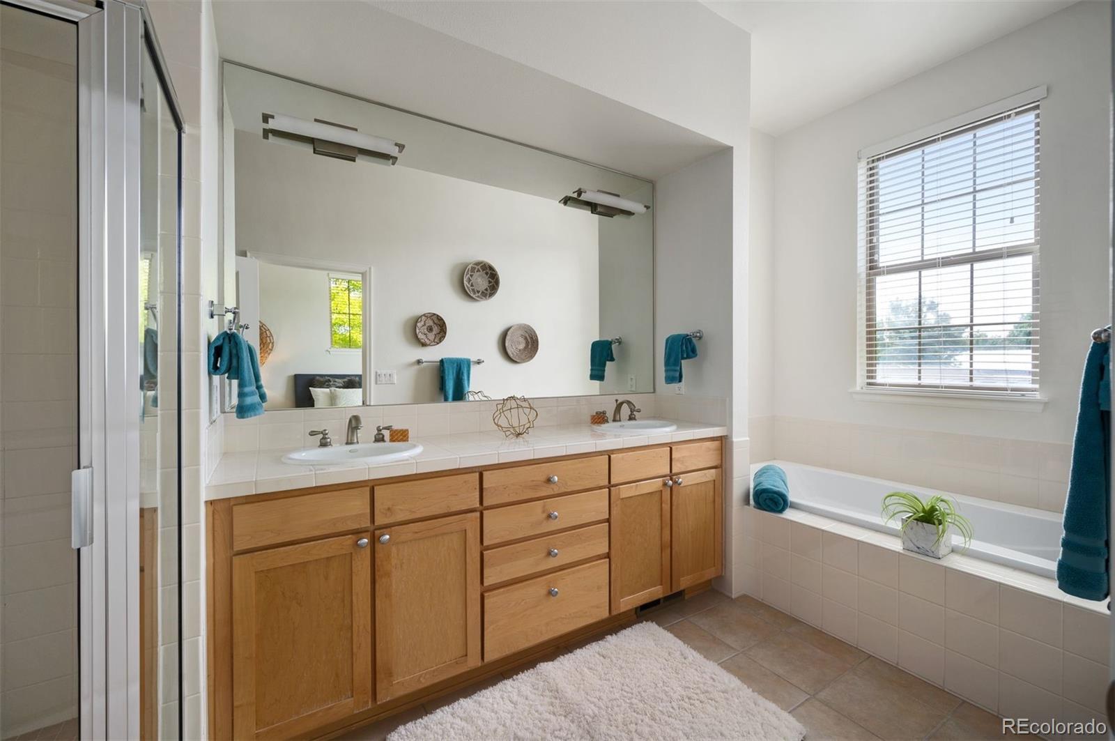 217 Spruce Street, Unit 101 Denver, CO 80230 - Photo 20 of 37 a bathroom with a granite countertop sink mirror and bathtub