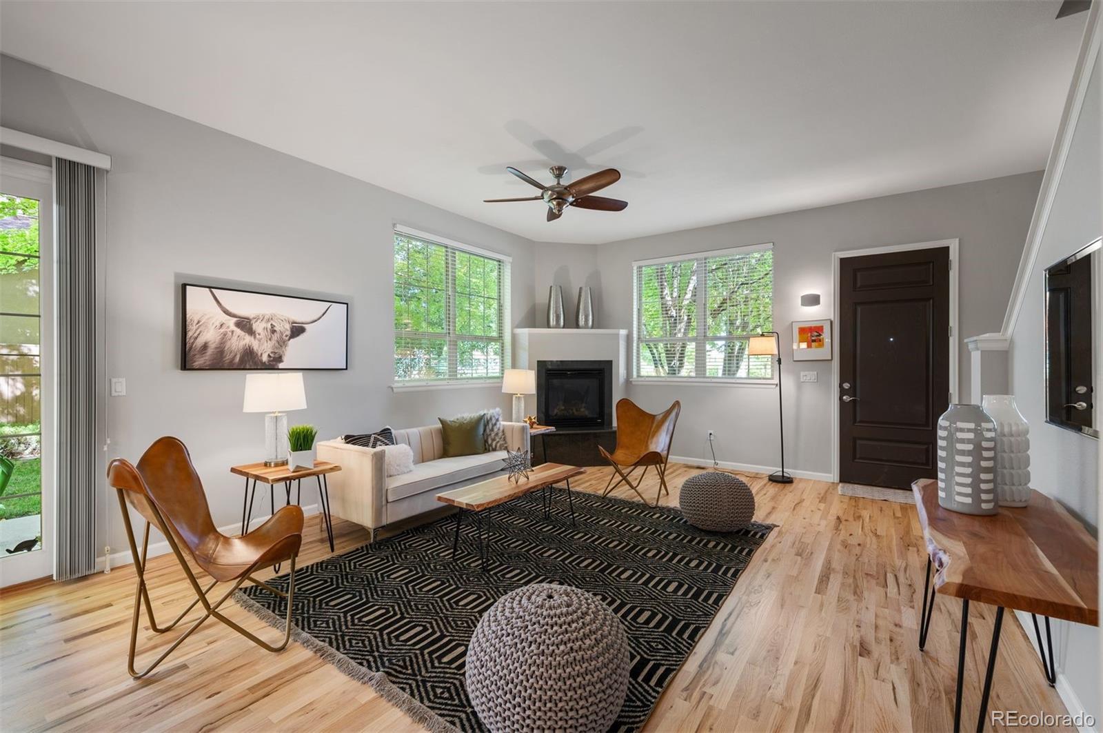 217 Spruce Street, Unit 101 Denver, CO 80230 - Photo 2 of 37 a living room with furniture two window and a fireplace