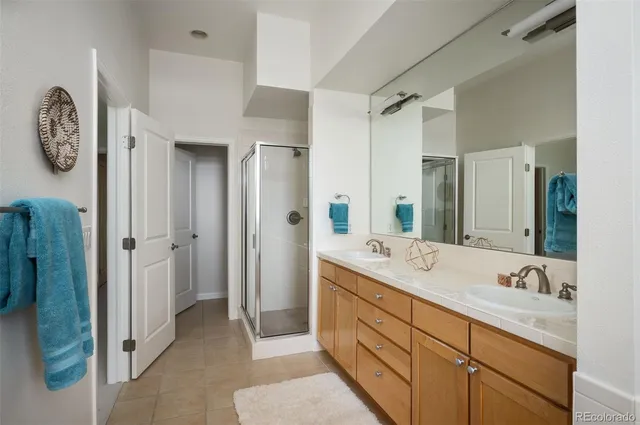 a spacious bathroom with a double vanity sink and a mirror