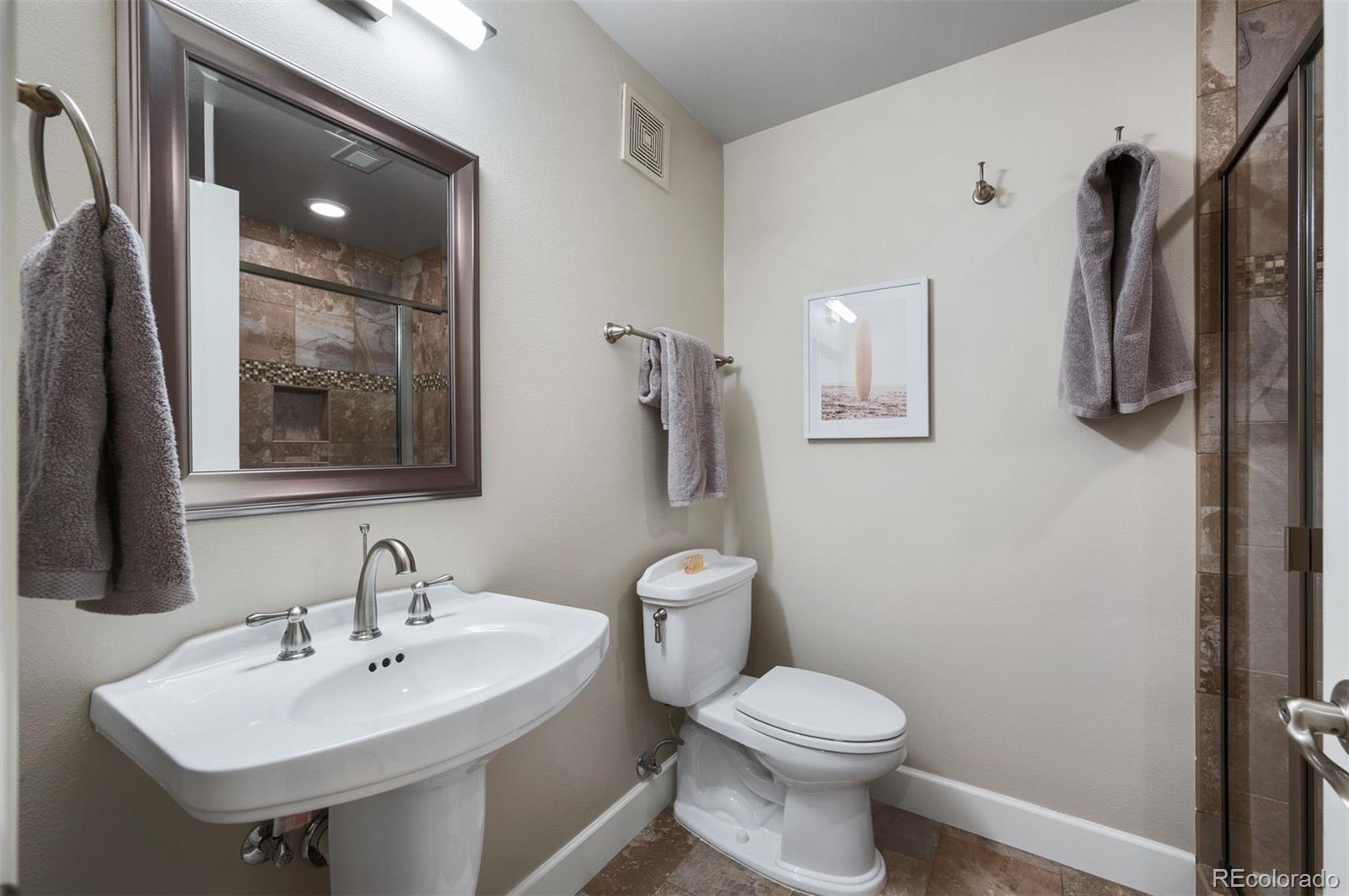 217 Spruce Street, Unit 101 Denver, CO 80230 - Photo 31 of 37 a bathroom with a sink toilet and shower