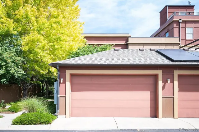 a front view of a house with yard and tree