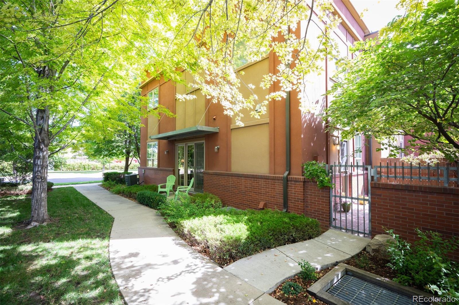 217 Spruce Street, Unit 101 Denver, CO 80230 - Photo 35 of 37 a front view of a house with a garden