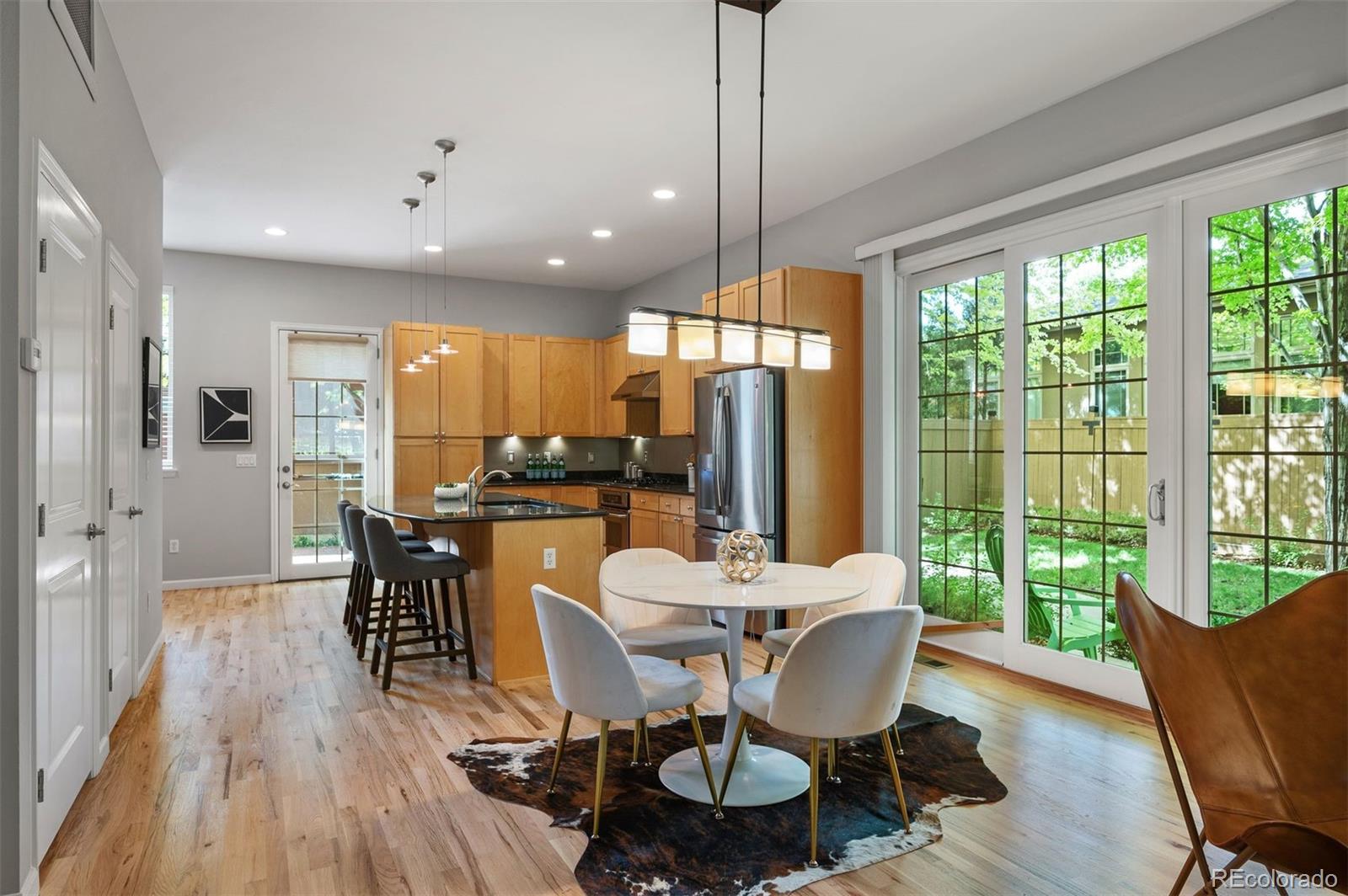 217 Spruce Street, Unit 101 Denver, CO 80230 - Photo 4 of 37 a view of a dining room with furniture window and wooden floor