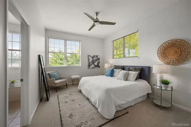 a bedroom with a bed couch and window