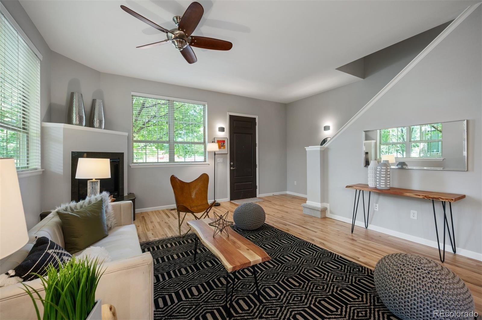 217 Spruce Street, Unit 101 Denver, CO 80230 - Photo 7 of 37 a living room with furniture a large window and wooden floor