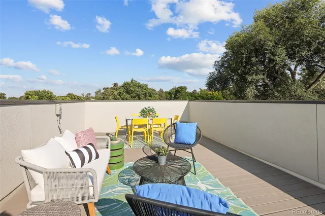 a building outdoor space with patio furniture and potted plants