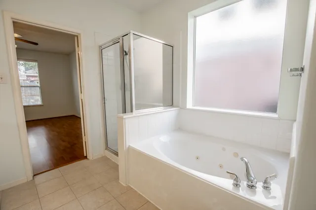 a bathroom with a bathtub and a shower