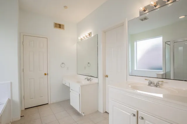 a bathroom with a double vanity sink a and mirror