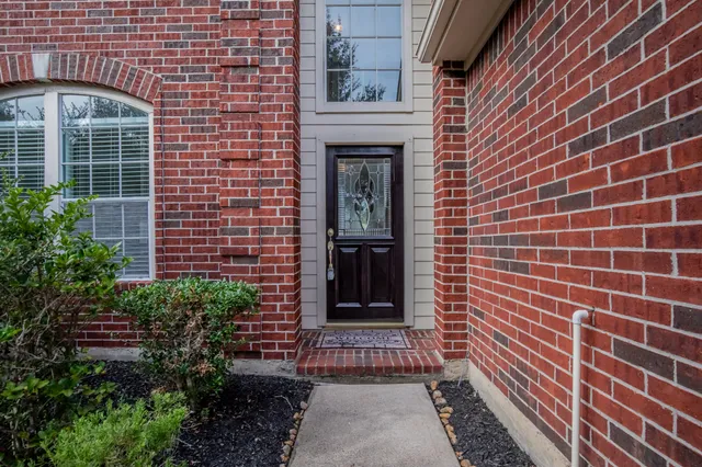 a view of front door of house with potted plant