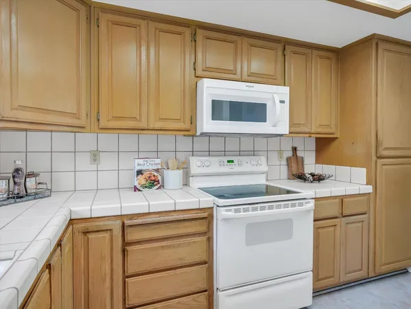a view of a kitchen with sink cabinets and appliances