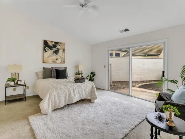a spacious bedroom with a bed and furniture