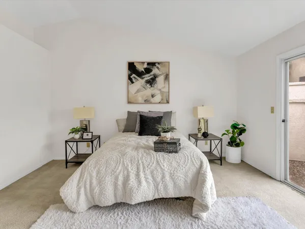 a bedroom with a bed and potted plant