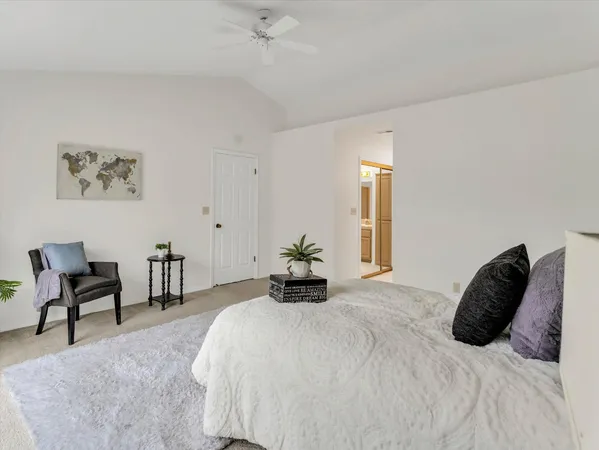 a bedroom with a bed and a chair