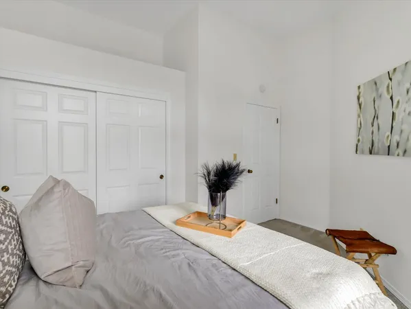 a bedroom with a bed and a potted plant